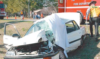 Log truck, car collide